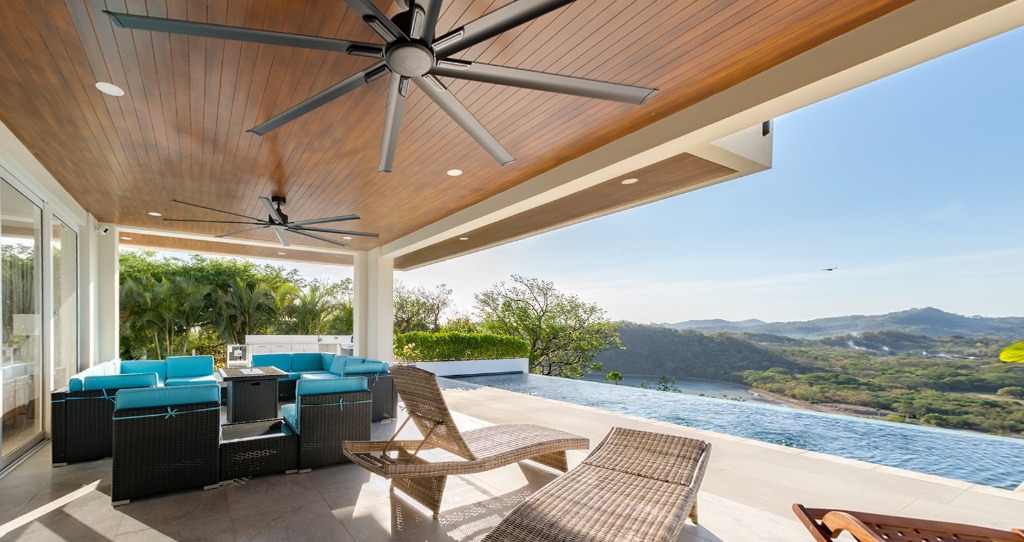 Covered outdoor lounge terrace and infinity pool with Pacific Ocean views