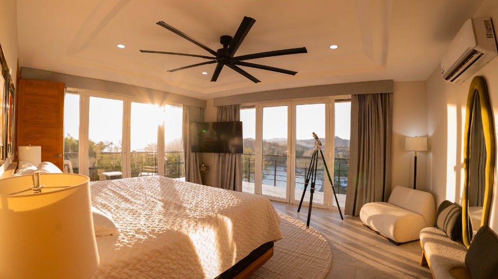 Golden hour view from the primary bedroom suite overlooking Nacascolo Bay